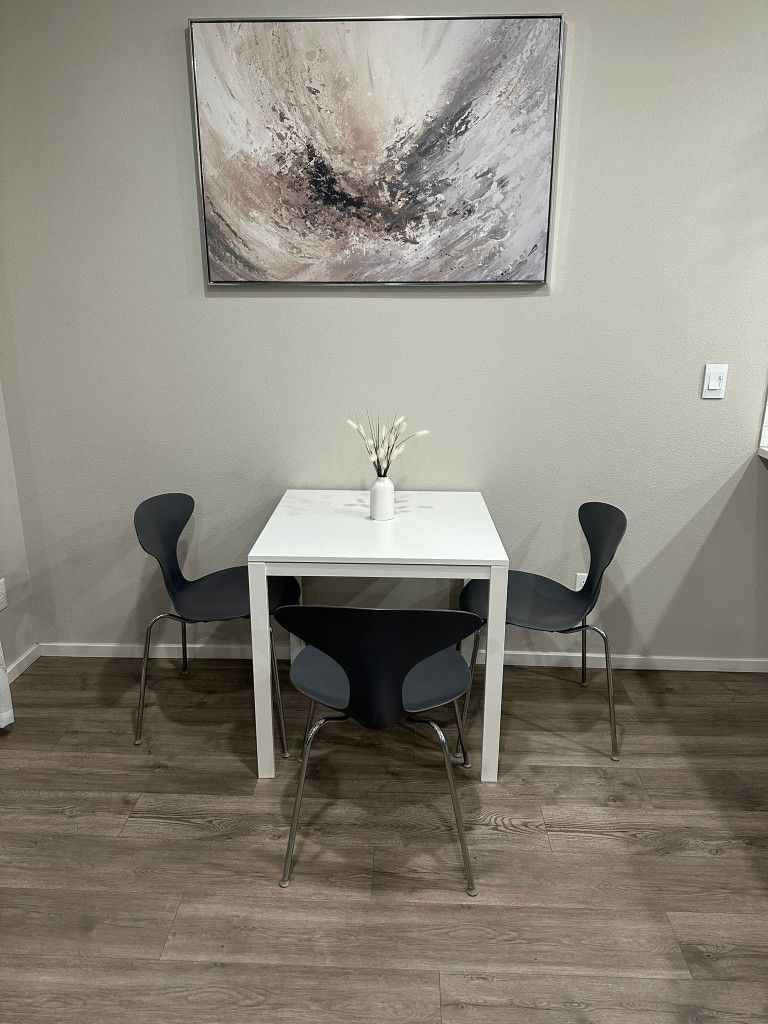 White Table and 3 Gray Chairs
