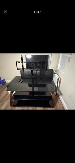 Whalen Payton 3-in-1 TV stand with black glass shelves and wooden side supports.