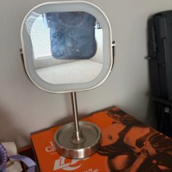 Double sided mirror with light