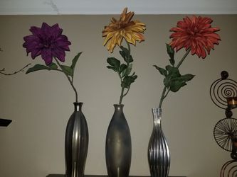 Cool metal vases with big colorful flowers