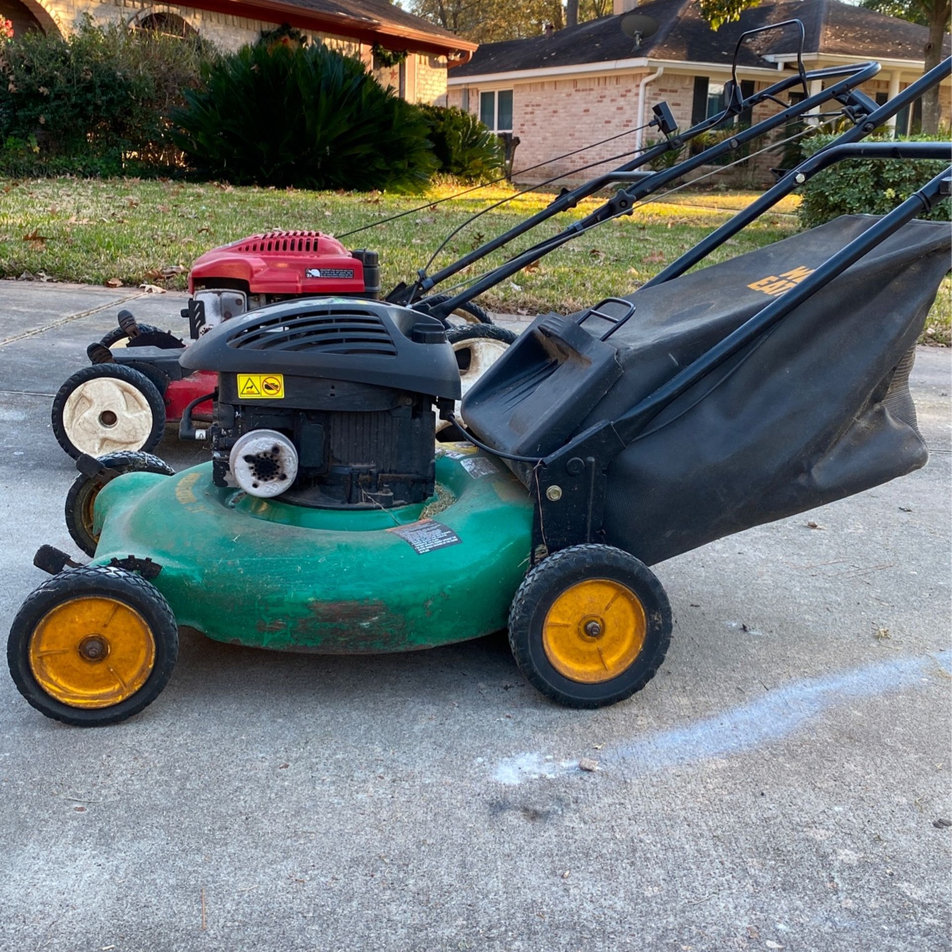 Two Running Lawn Mowers
