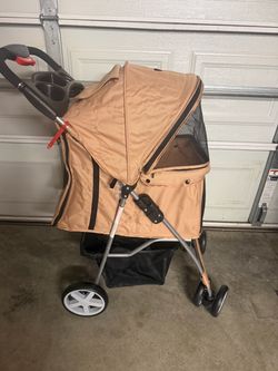 Never used tan colored dog stroller and free doggy car seat