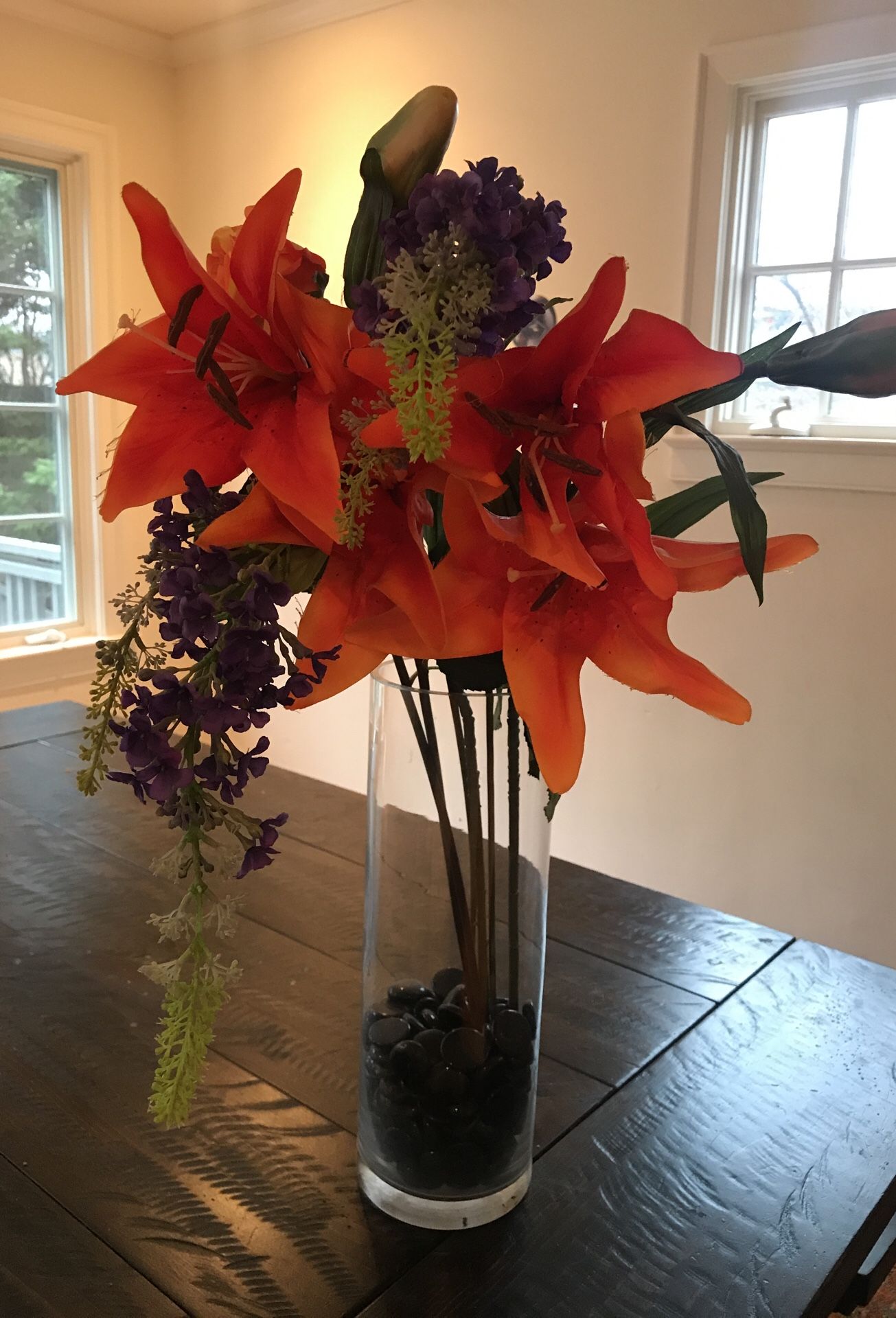 Fabric flower arrangement with vase and decorative stones