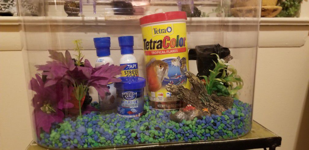 Fish Aquarium. Includes 2 filters. One is a back up. Fish food and accessories. Tank has 5 different light settings as well.