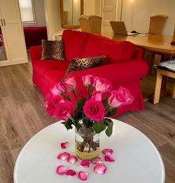 IKEA Loveseat, LIKE NEW. Custom made washable removable cover in Rose Red.