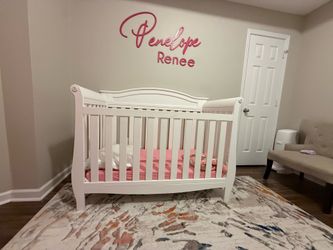 White crib with mattress.