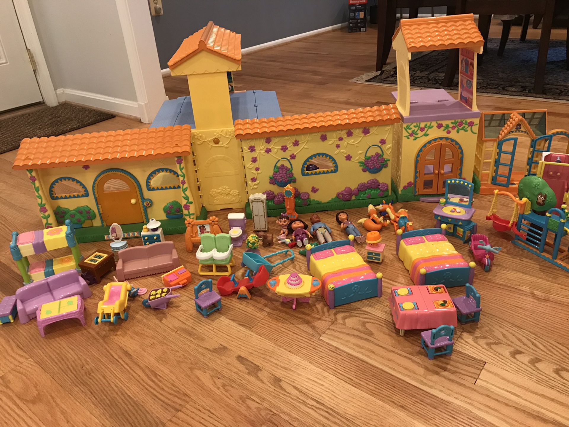 Dora’s pop up talking house with lots of figurines and furniture