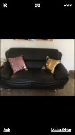 Two leather couches two side tables and a coffee table