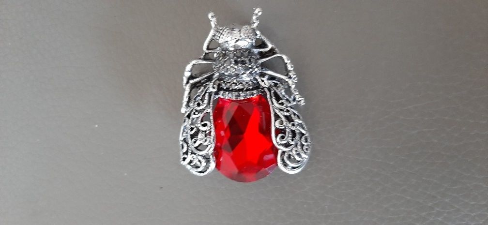Insect Brooch with a red gem & silver tone detailing.