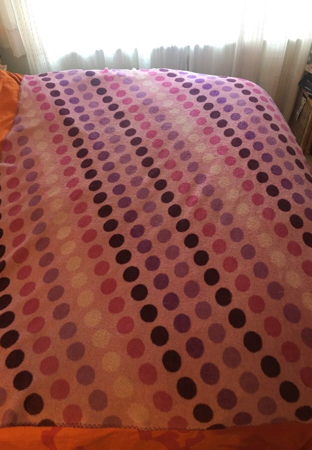 Purple and pink polka dotted throw blanket