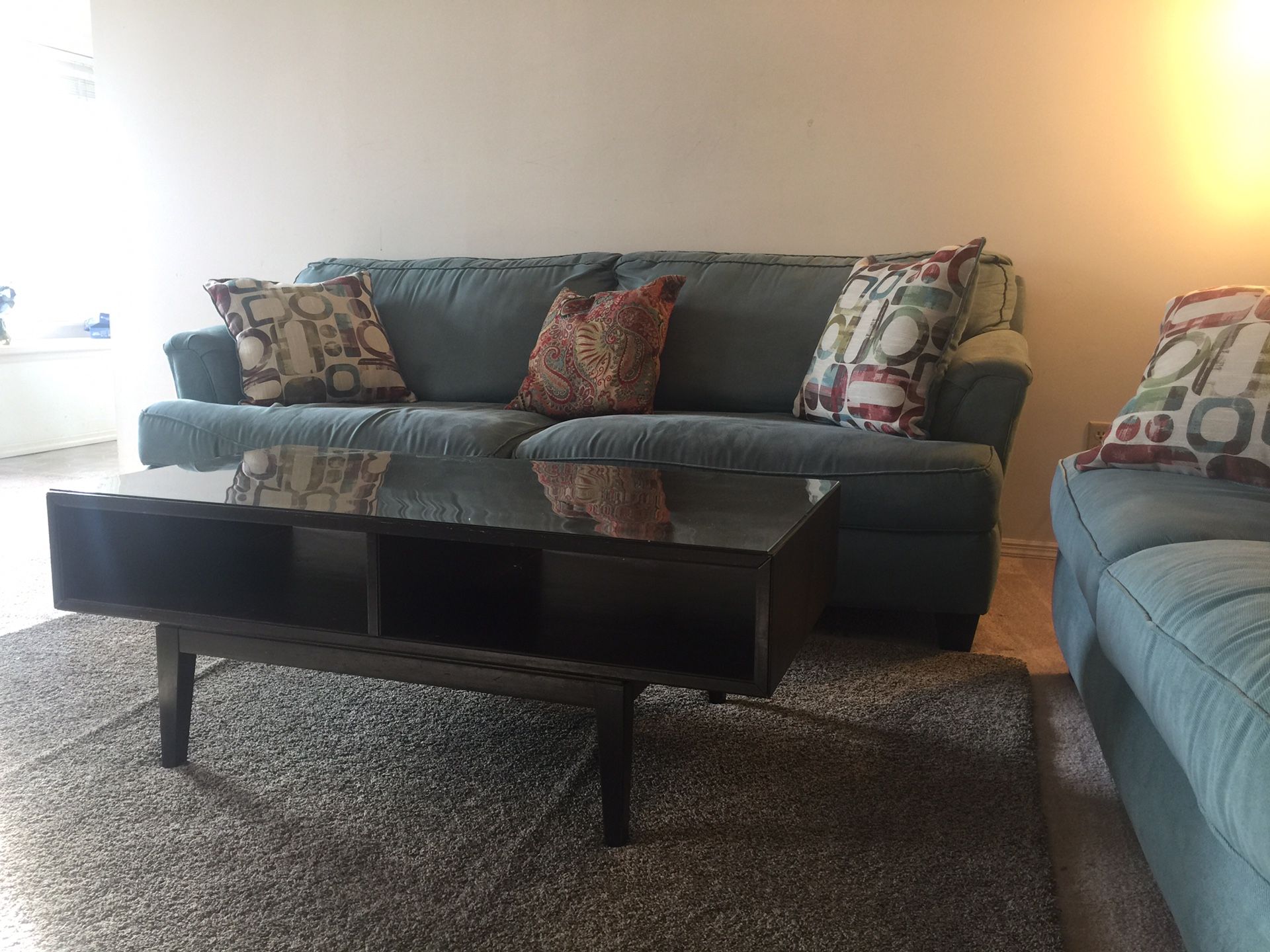 Two sofa, a coffee table, and blue rug.