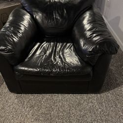 1 Black Faux Leather Couch. 2 Black Faux Leather Chairs.