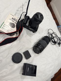 Canon EOS Rebel T3 1100D Camara with lenses ,battery, charger,manual,cds box included