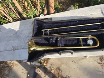 Conn Beginner trombone. Has plenty of small Dents.. One of the welds is loose. cases in bad shape