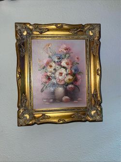 This vintage floral still life oil painting is signed by artist P. Keeling and features a thick impasto technique in a decorative gold frame.