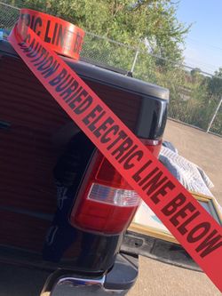 Caution buried electric line below roll