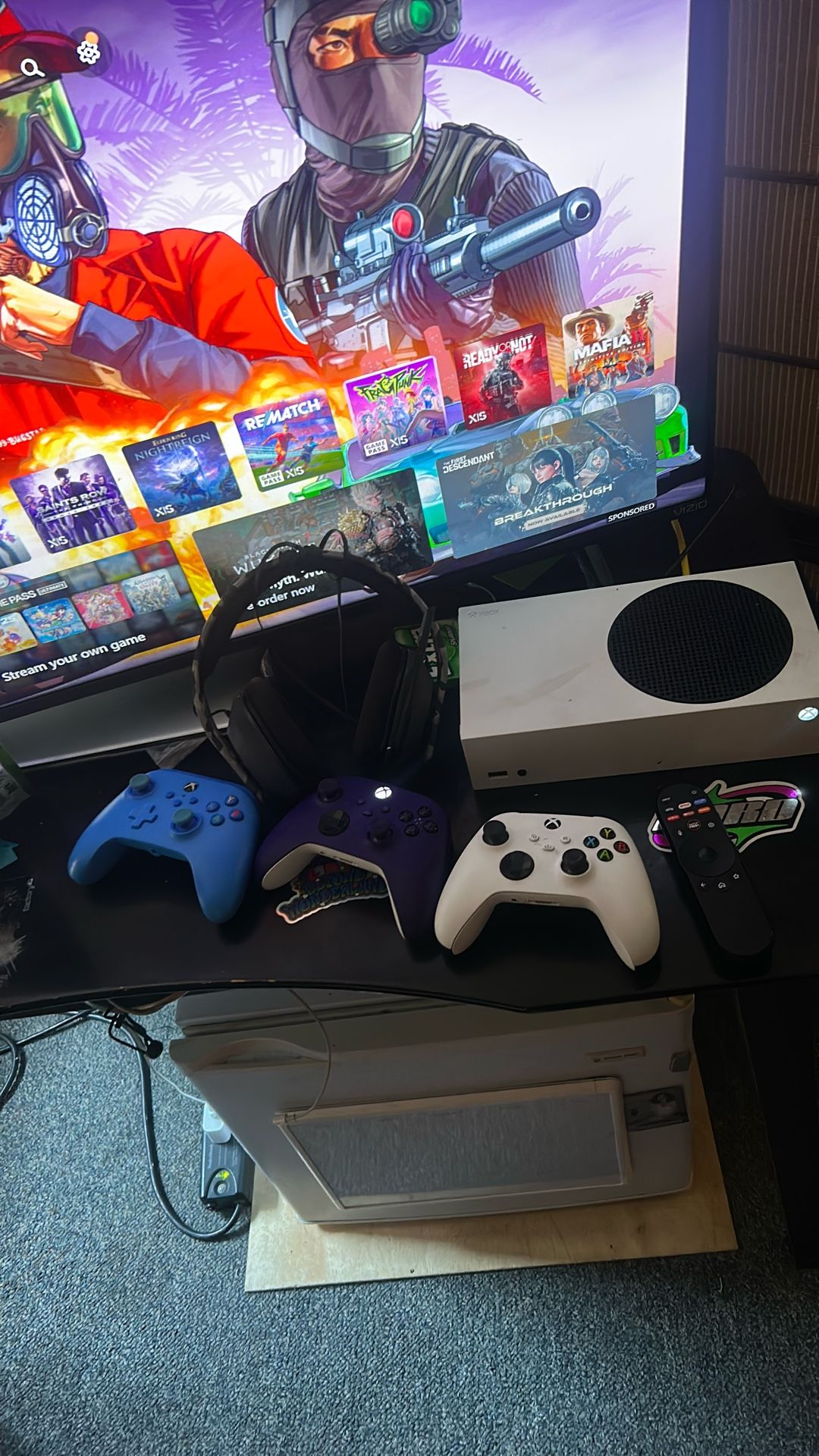 xbox series x with 3 controllers and a mic