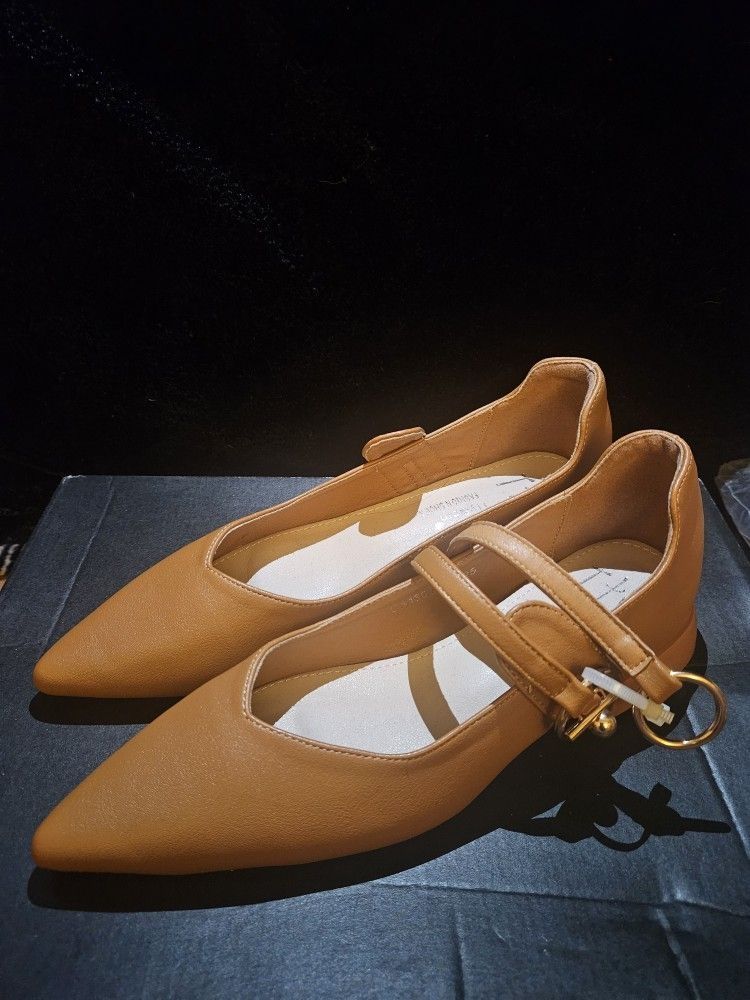 Tan and cream leather Mary Jane flats with buckle closure and 1.5" heel.
 Size 5.5 W 