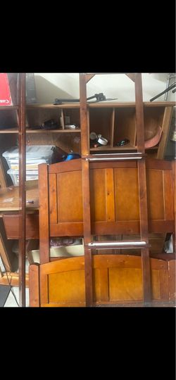 Twin  bed frame with mattress also computer desk behind the frame