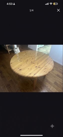 Wooden dining table with glass on top
