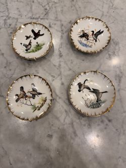 vintage decorative porcelain plates featuring hand-painted game bird and waterfowl illustrations