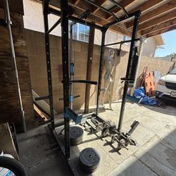 Power Cage with pulley system and dumbbells and plates 