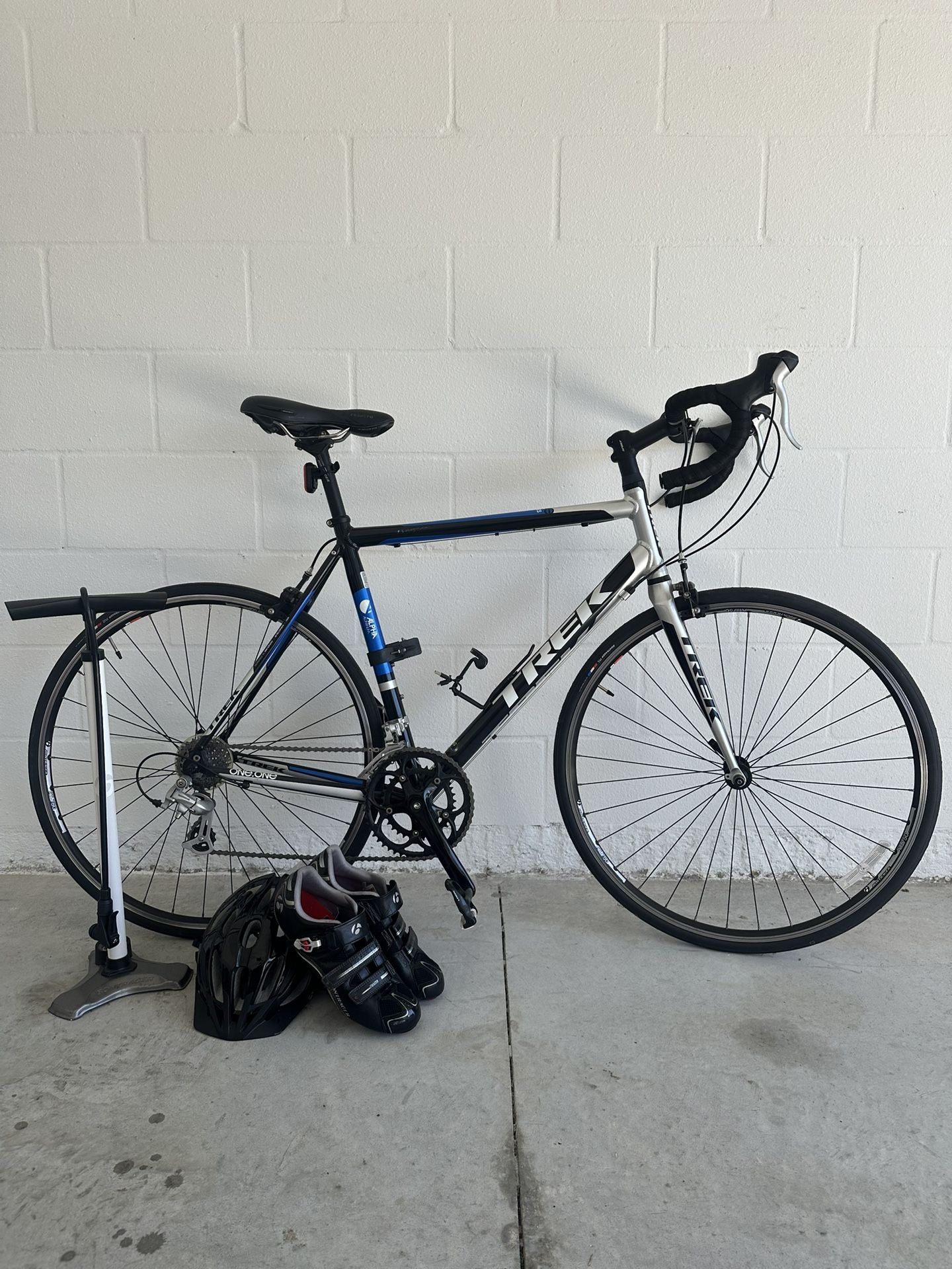 Trek One Series Road Bike with shoes, helmet, and pump