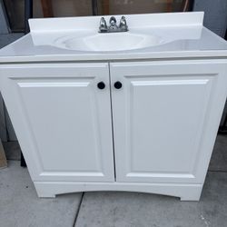 white bathroom vanity with an integrated sink 