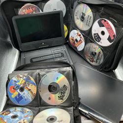 2 DVD Players And Two Books Of DVDs. 