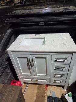 bathroom vanity with marble and a sink