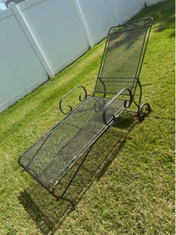 a vintage wrought iron chaise lounge