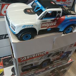 Brushless electric ARRMA Mojave BLX 2s-3s RC truck including remote controller battery and a charger