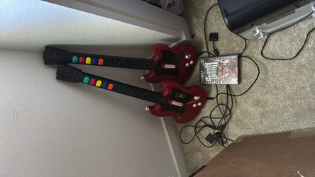 Two Redoctane PS2 Guitar Hero guitars and Guitar Hero 2