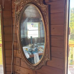 An antique mirror in a frame 