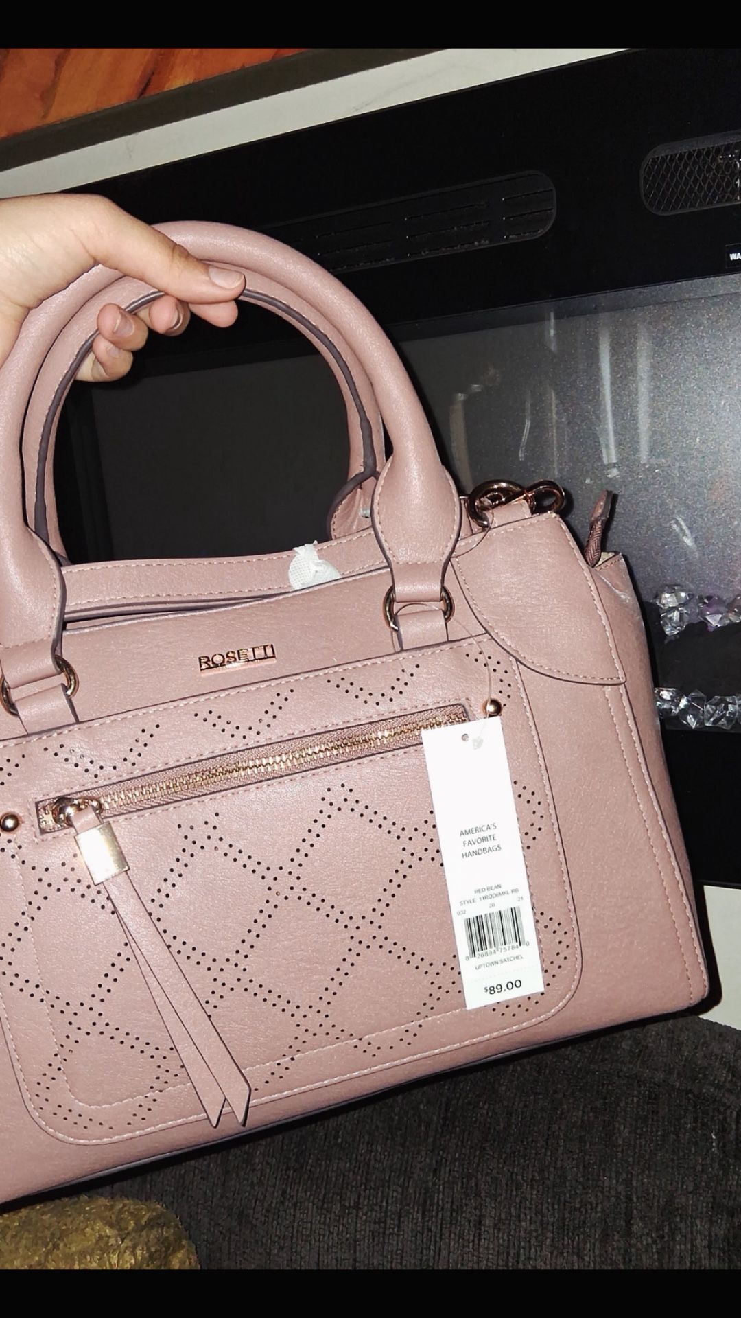 Pink leather bag with crossbody attachments