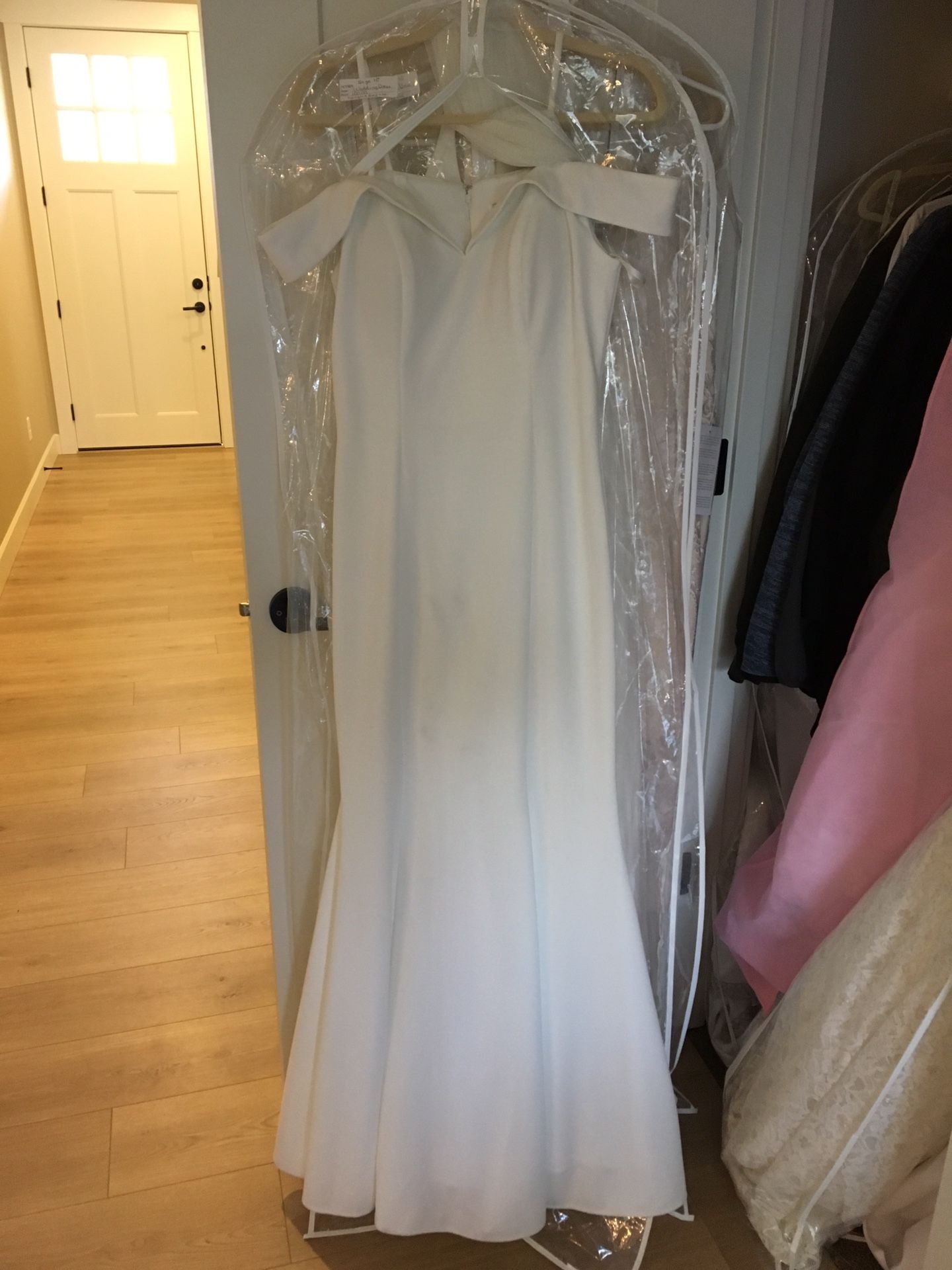 Size 10 wedding dress. Off white with off white shawl. No beads or sequins. Simple classic. No train. Worn once. Great condition.