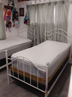 White metal twin beds