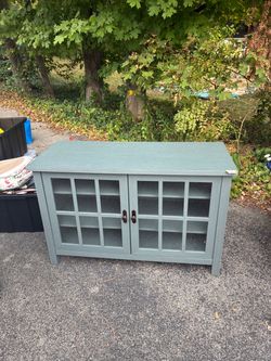 Blue-Gray Wood Cabinet with Glass Panel Doors