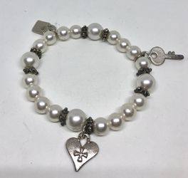 Silver tone bracelet with faux pearls and charms