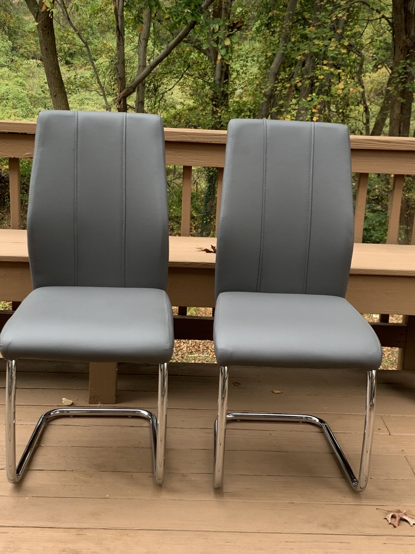 New pair of Modern Grey Chairs with Faux Leather, Chrome legs. $95 OBO