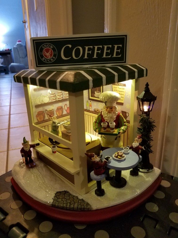 New Roman Collectibles Santas Coffee Shop Moving Musical Light Up Christmas Amusements Figurine
(8.25"H x 6.75"W x 6.75"D")