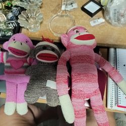 Three Sock Monkies One Red And White One Brown And One Pink And White
