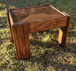 Solid wood, with glass top coffee table made by Avanti.