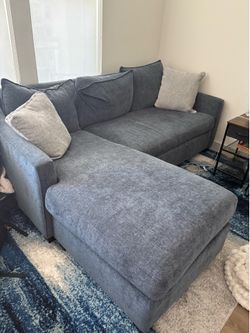 Blue couch with reversible ottoman and foldable bed