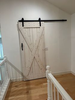 Whitewashed sliding wooden barn door
