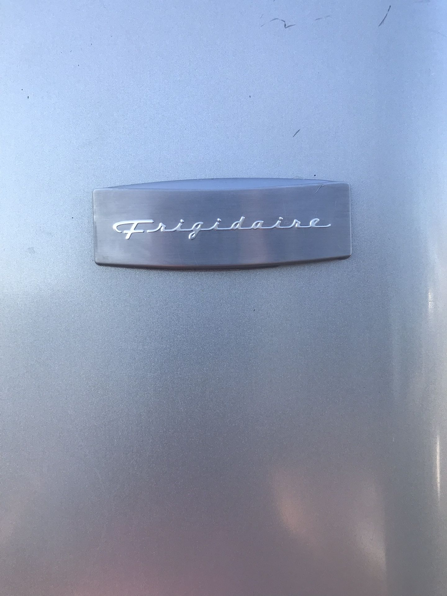 Stainless steel and black apartment full size Frigidaire refrigerator