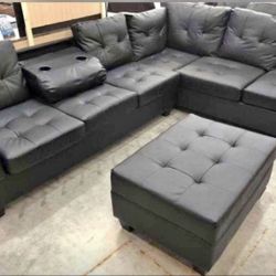 Black Reversible Sectional With Cup Holder And Storage Ottoman. Brand New. 
