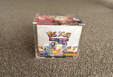 Pokémon Surging Sparks booster box with acrylic case
