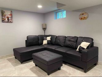 New stock black faux leather sectional with storage ottoman and pillows