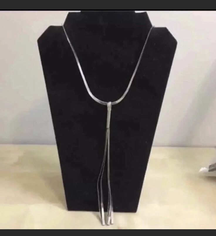 Silver tassel in flat silver chain